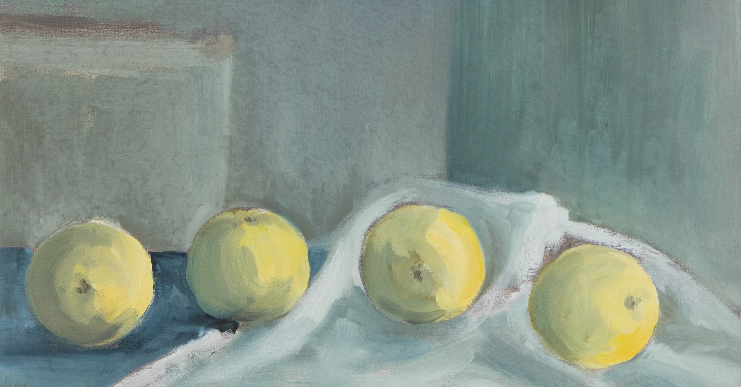 Still life of green apples on a blue-grey surface