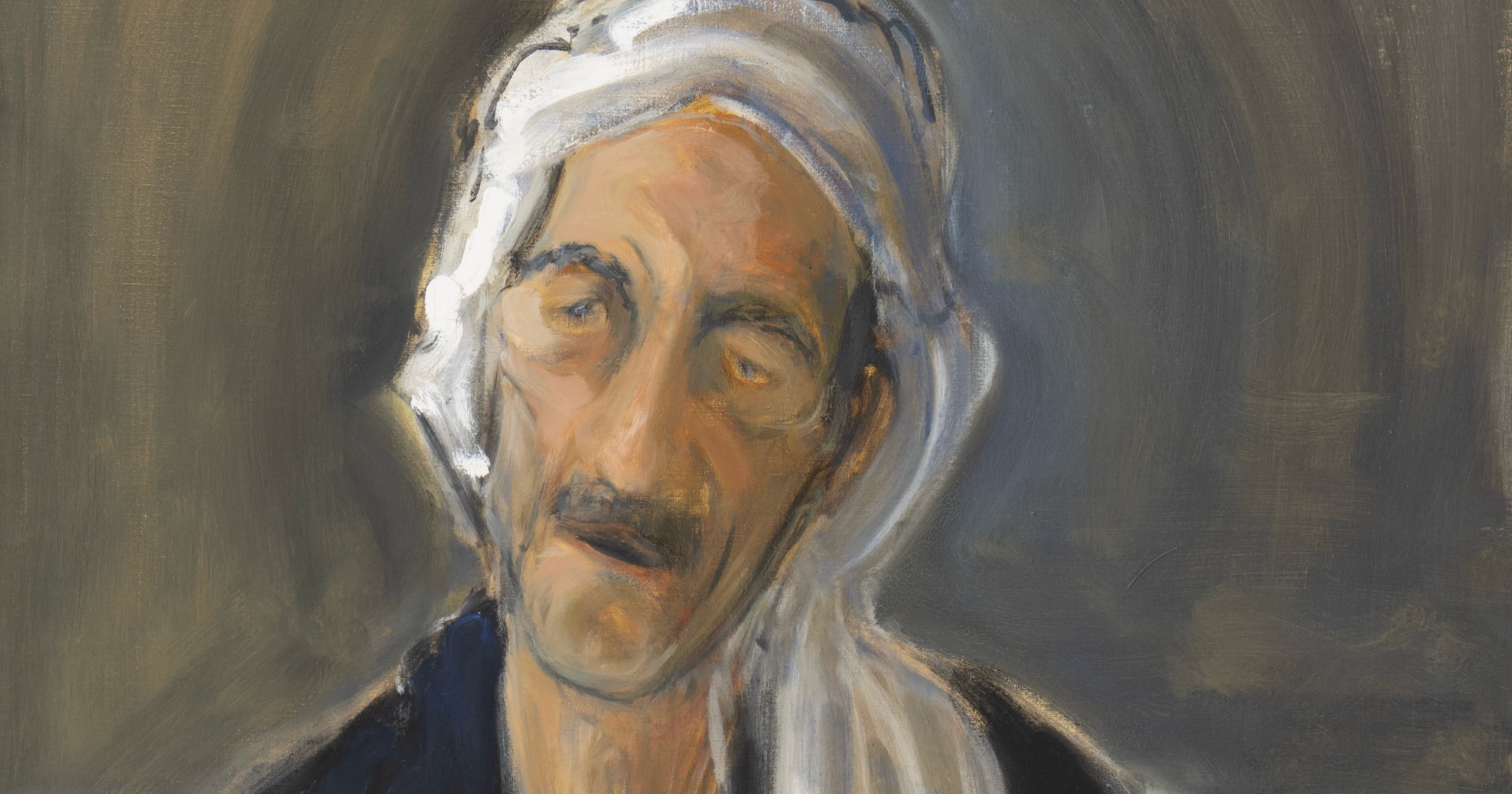 Portrait of a man wearing a white headscarf
