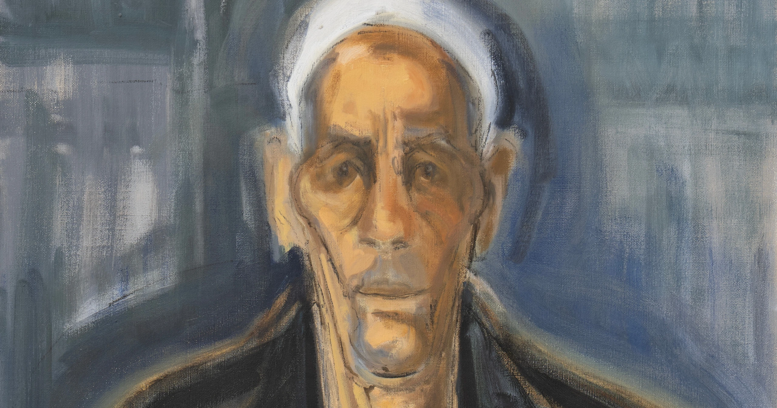 Portrait of a man against a blue-grey background