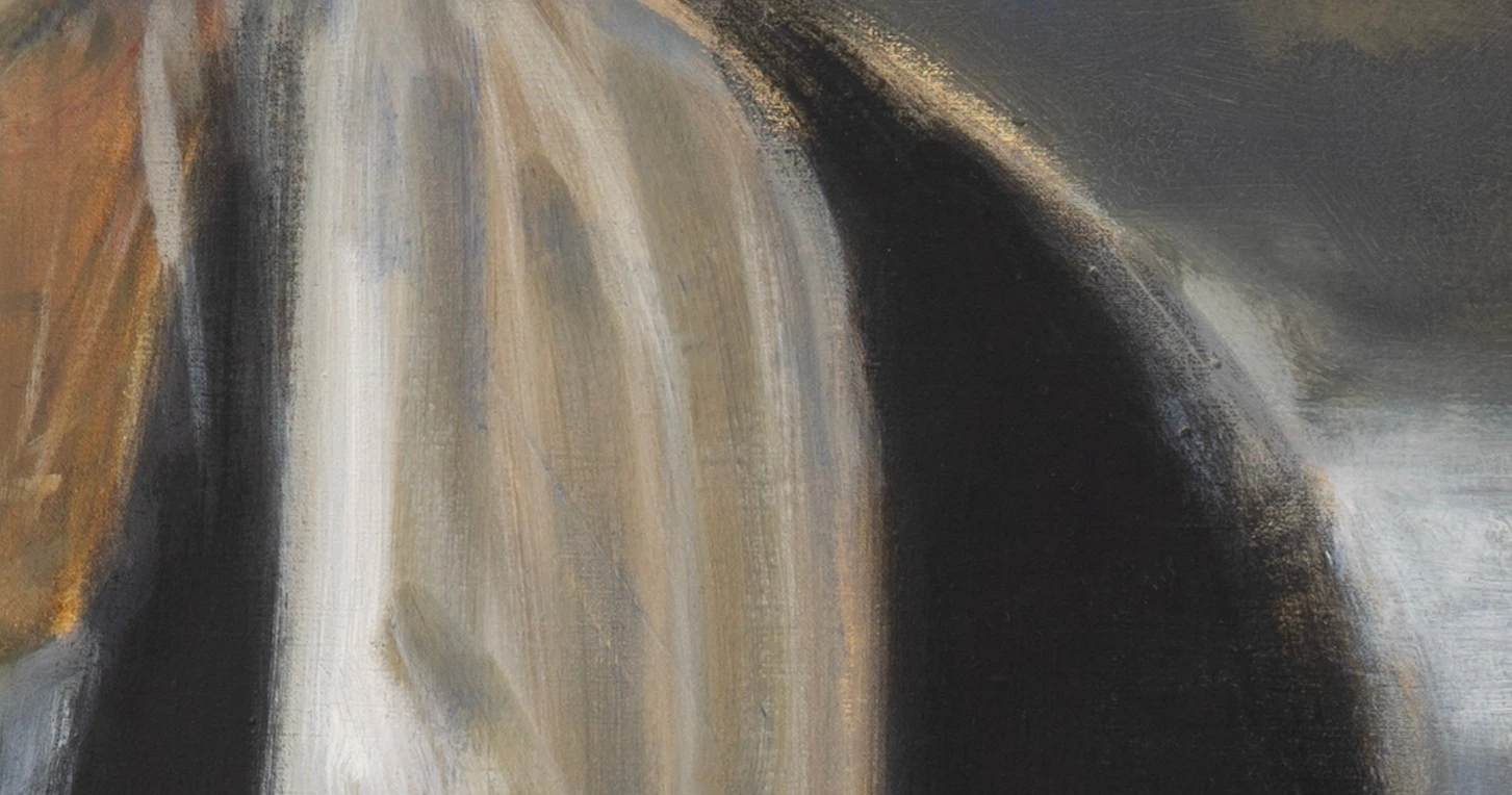Detail of a white headscarf against a dark background