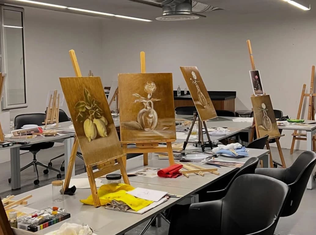 Still-life paintings on easels during a workshop